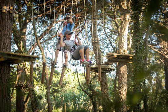 A primer pla kayak pel riu ter amb un noi i una noia, semblen joves. i a darrera un altre kayak amb una parella, semblen els pares